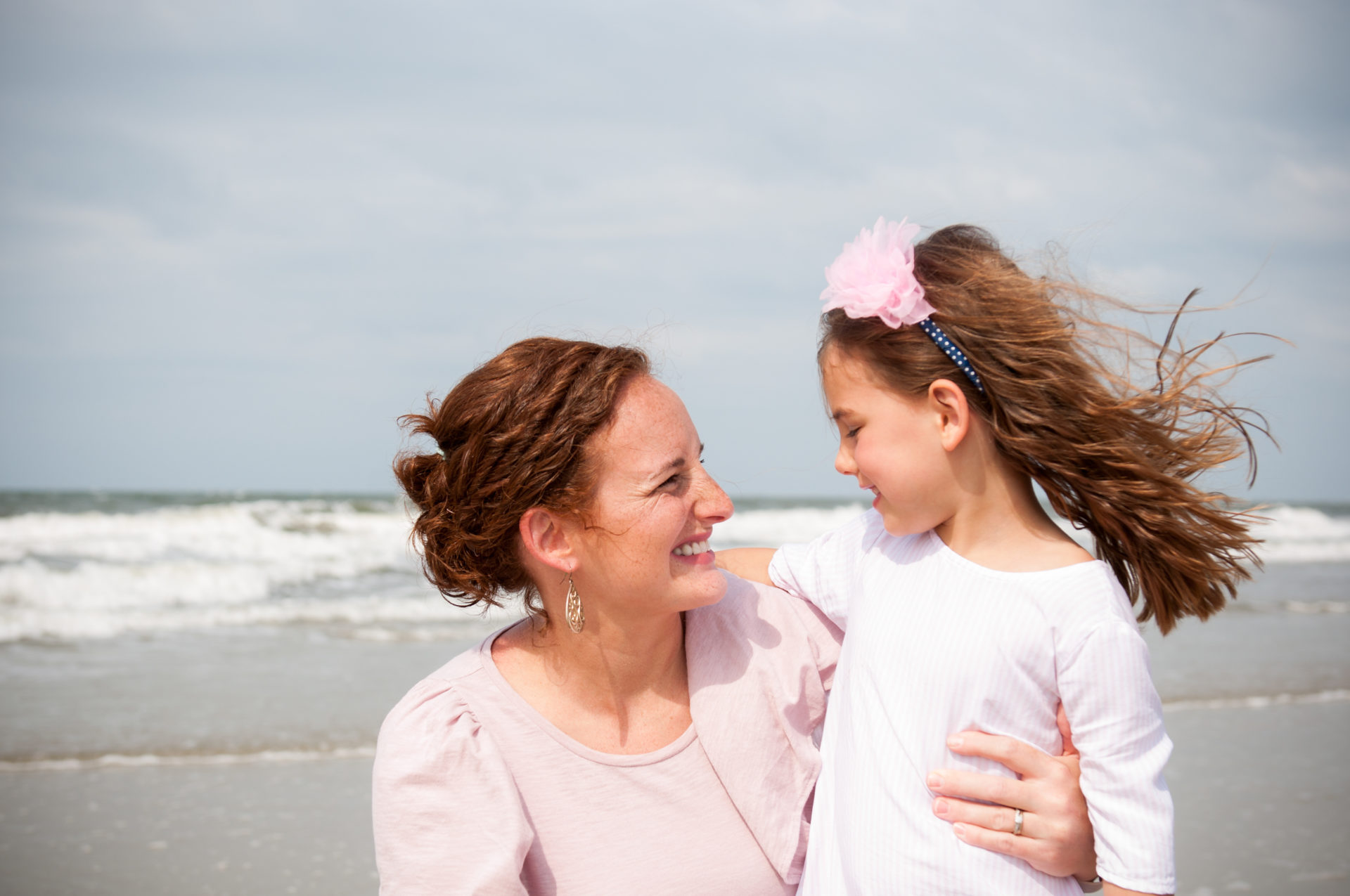 mom and young daughter on the beach
